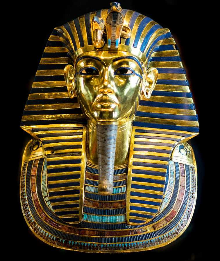 La máscara, de oro macizo; presenta ‘el retrato oficial’, como se ve también en las estatuas de Karnak etc. Pero en la tumba se ven muchas caras distintas. Y el rostro de la momia es bien distinto.